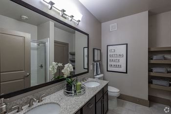 Bathroom with two sinks and a large mirror